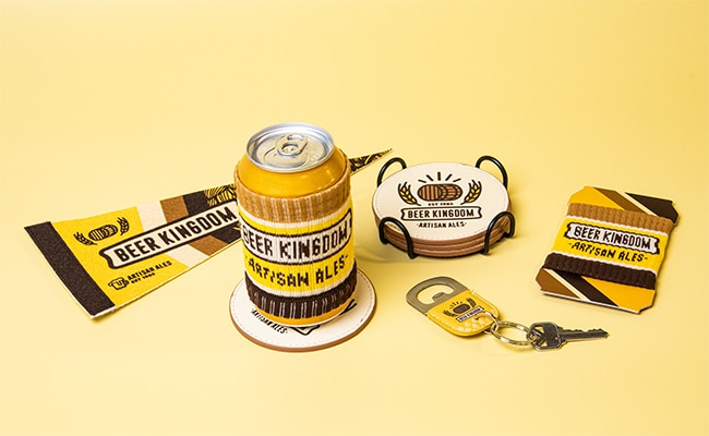 https://poppromos.com/wp-content/uploads/2023/01/Beer-Kingdom-Can-Cozy-Group-on-Yellow-2-copy-1.jpg